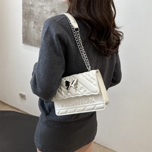 Quilted white crossbody bag with silver butterfly buckle and metal chain strap