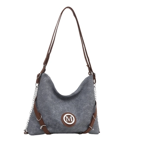 Gray canvas tote bag with leather straps and metal M logo, casual multi-use backpack style