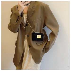 Mini black suede flap bag with gold chain strap styled with casual blazer and trousers