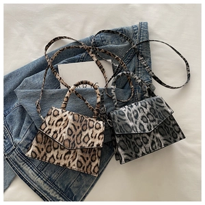 Detail view of leopard print mini crossbody bag in brown and grey synthetic leather