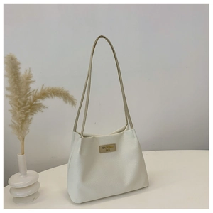 Detail of cream white tote bag with woven texture and Tidal Dryness central leather tag