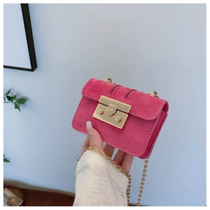 Detailed shot of fuchsia mini crossbody bag with gold metal chain and push-lock closure
