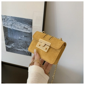 Detail of yellow mini chain bag with textured suede finish and gold metal buckle lock