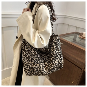 Detail shot of the large leopard print tote bag with thick knit texture on model's shoulder