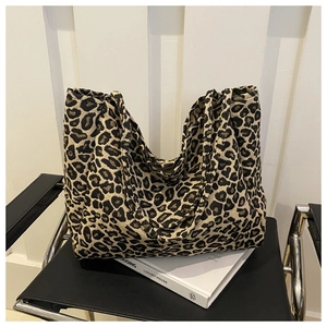 Minimalist leopard print tote bag in soft canvas on black chair with white background