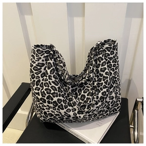 Minimalist black and white leopard print canvas tote bag on a modern home background