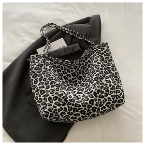 Close-up of leopard print canvas tote bag showing thick texture and dual handles