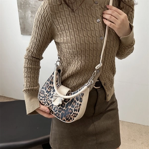 Leopard print crescent shoulder bag with silver bow detail and cream leather trim