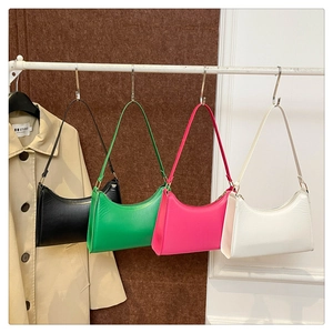 Hobo bags in four colors hanging on a rack showing minimalist design and matte leather texture