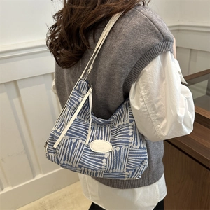 Blue and white plaid canvas tote bag with slim shoulder strap for casual daily use