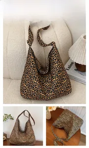 Detail view of large leopard print canvas tote bag on a white sofa with cozy lighting