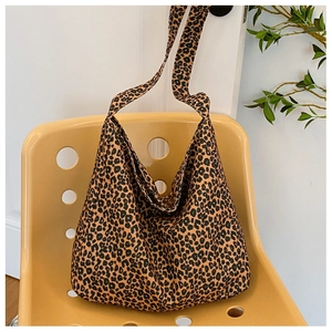 Chic leopard print hobo bag in durable canvas hanging on a stylish yellow chair
