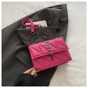 Detail of rose pink quilted crossbody bag with silver SS logo and chain strap