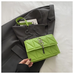 Detail of neon green PU leather bag featuring 3D triangle quilting and silver SS logo