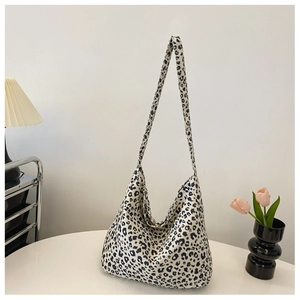Leopard print canvas tote bag detail on a warm interior background with a lamp