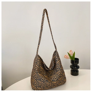 Detail of trendy leopard print canvas hobo bag showing spacious design and strap