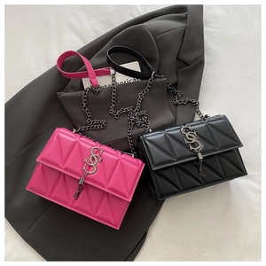 Detail of crossbody bags featuring triangle quilting and silver S-shaped buckle with tassels