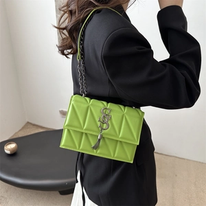Quilted lime green leather crossbody bag with chain strap and metallic tassel