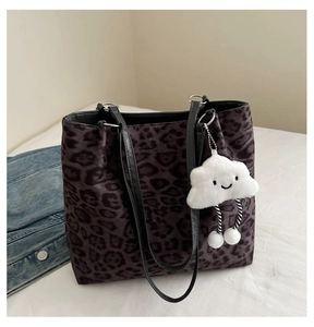 Close-up of leopard print tote bag with soft fabric texture and white cloud charm