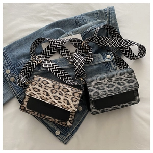 Detail of leopard print crossbody bag with wide patterned strap and gold hardware