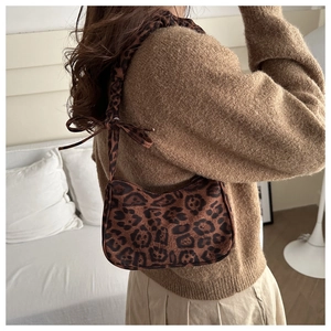 Close-up of leopard print underarm bag featuring a stylish bow knot on the shoulder strap