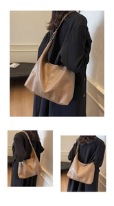 Detailed view of the wrinkled leather texture and wide strap of the brown Hobo tote bag