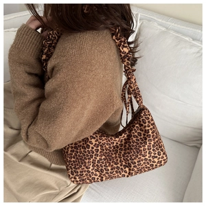 Detail of trendy leopard print hobo bag with a soft scrunchie shoulder strap design