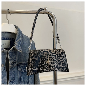Détail du sac à bandoulière léopard avec boucle étoile argentée et longue lanière