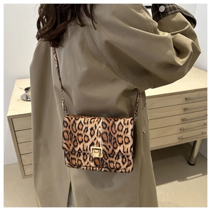 Leopard print crossbody bag styled with a khaki trench coat for an autumn fashion look
