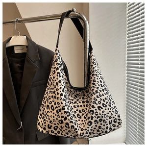 Detail shot of leopard print canvas shoulder bag showing hobo style and large capacity