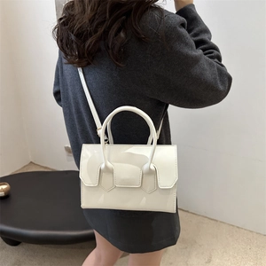 Minimalist white rectangular handbag with crossbody strap and cylindrical top handles