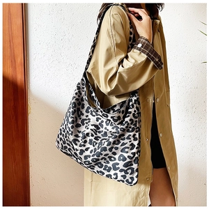Leopard print hobo bag with wide shoulder strap shown in a stylish autumn fashion outfit