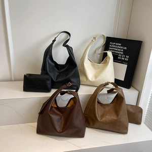 Minimalist large-capacity tote bags set in black, cream, and brown textured faux leather
