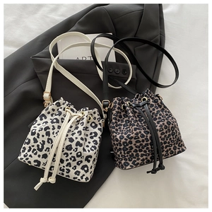 Detail of leopard print bucket bag with drawstring closure and adjustable slim straps