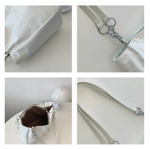 Détails du sac cabas blanc minimaliste montrant les finitions argentées et la doublure brune