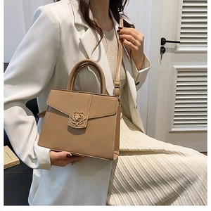 Chic khaki faux leather handbag styled with white blazer and cream pleated skirt