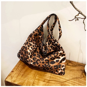Macro shot of stylish leopard print tote bag fabric and soft wide shoulder strap detail