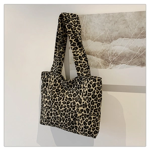 Detail view of the durable leopard print canvas texture and fabric weave on this tote bag