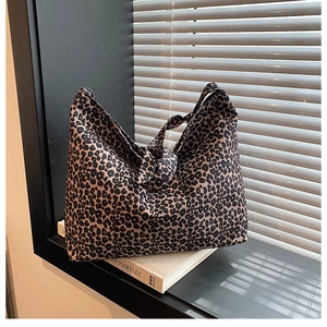 Detail of leopard print canvas tote bag featuring unique knotted handle and large capacity