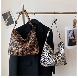 Detail of leopard print tote bags in brown and cream colors with shoulder knot designs