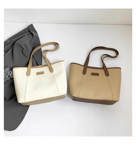 Close-up of large trapezoid tote bags with FASHION leather tag and stylish long straps