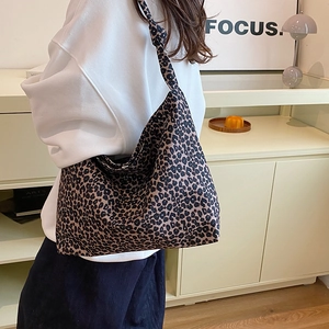 Large leopard print tote bag with soft canvas texture and stylish knot shoulder strap detail