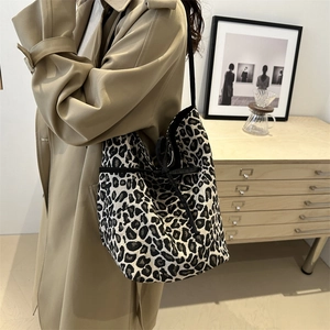 Leopard print tote bag with black drawstring closure and stylish shoulder strap