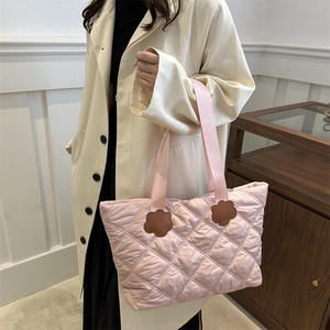 Quilted light pink oversized tote bag with diamond stitching and flower accents