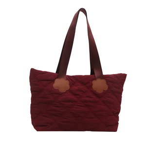 Burgundy quilted tote bag with diamond pattern and floral accents for autumn winter fashion