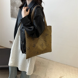 Retro mustard yellow tote bag with letter print pattern shown on female model