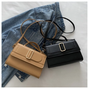 Detail of minimalist black and khaki square shoulder bags with metallic rectangle buckle