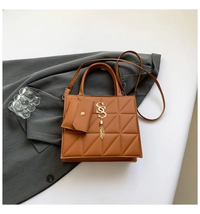 Brown quilted crossbody bag with golden SS logo, tassel, and mini coin purse detail