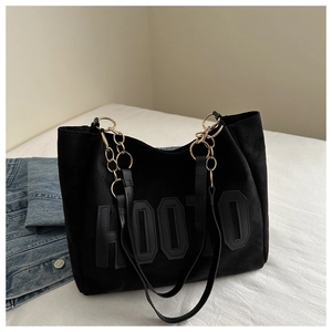 Dettaglio borsa tote nera con patch HOOTO e tracolla a catena color oro