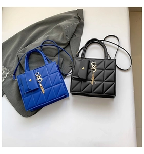 Detail of quilted crossbody bags with SS logo, metal tassels, and matching side pouch